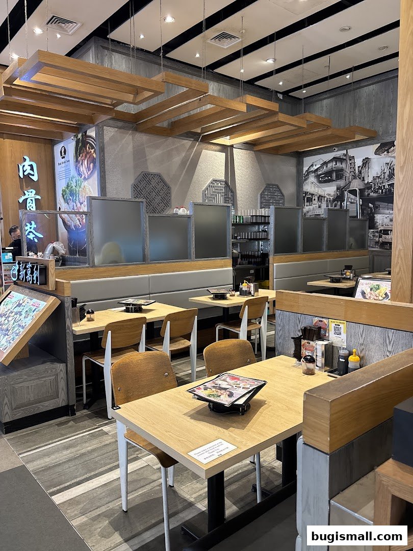 Interior view of a Bak Kut Teh restaurant with wooden tables and chairs.