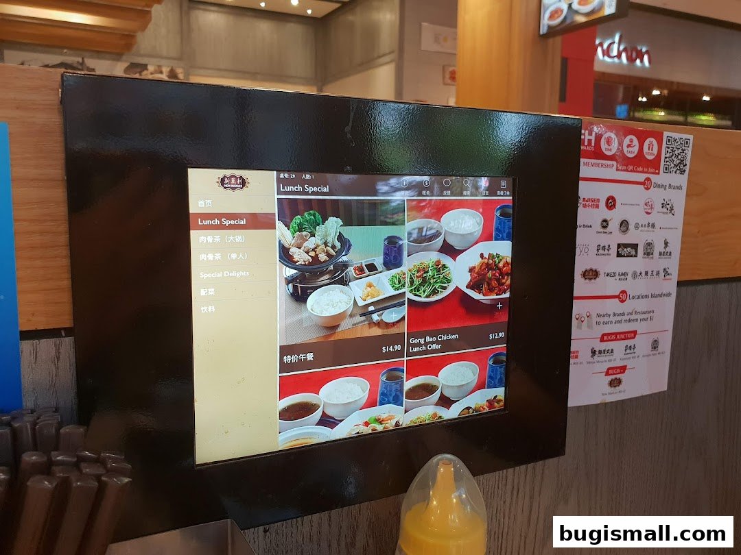 A digital menu displaying lunch specials and various dishes at New Manlee Bak Kut Teh.