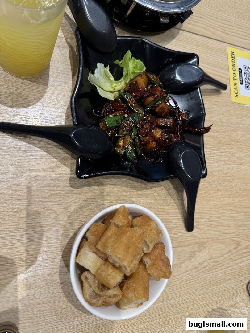 A close-up of a delicious meal with fried dough sticks and a savory dish.