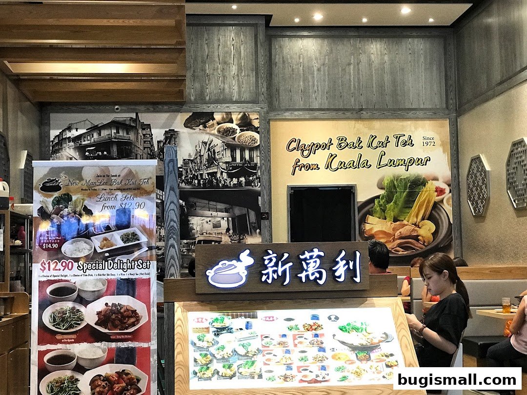 Interior of a restaurant with a menu display and promotional posters for Bak Kut Teh.