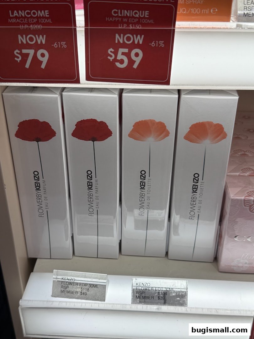 Perfume bottles and promotional tags displayed on shelves at Novela Bugis.