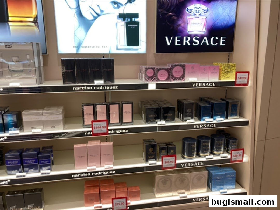 Shelves stocked with various designer perfumes from brands like Versace and Narciso Rodriguez.