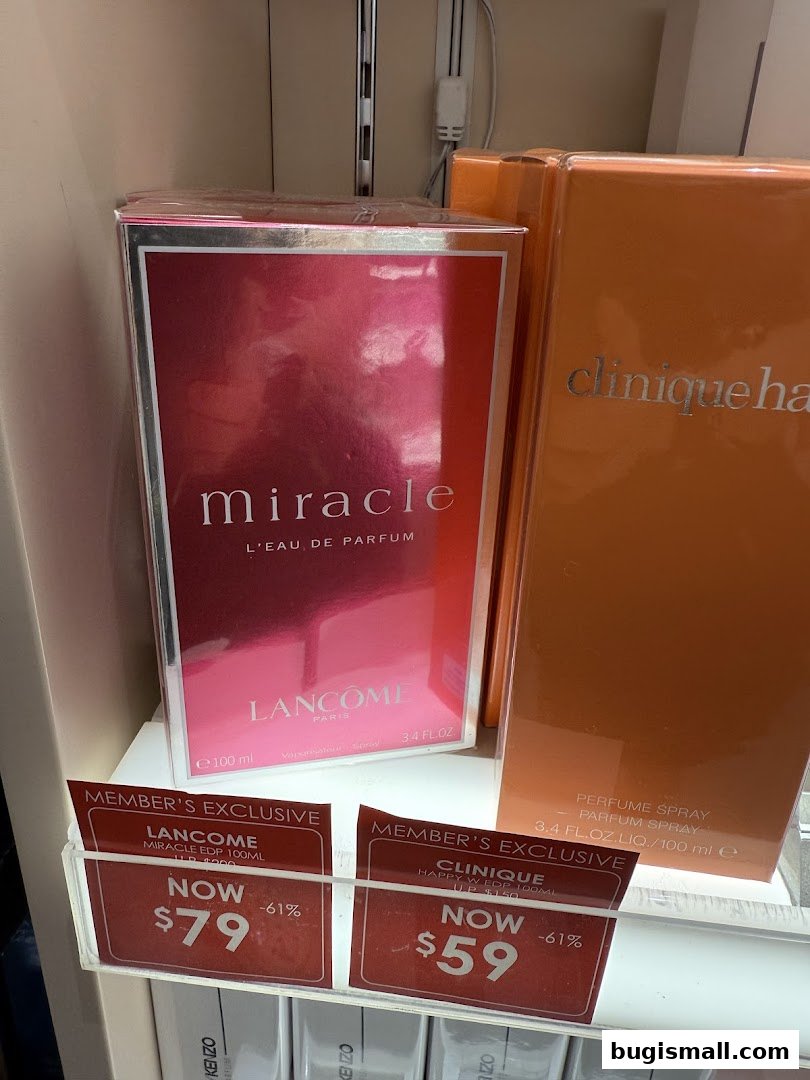A display of Lancome Miracle and Clinique Happy perfumes with member exclusive pricing.
