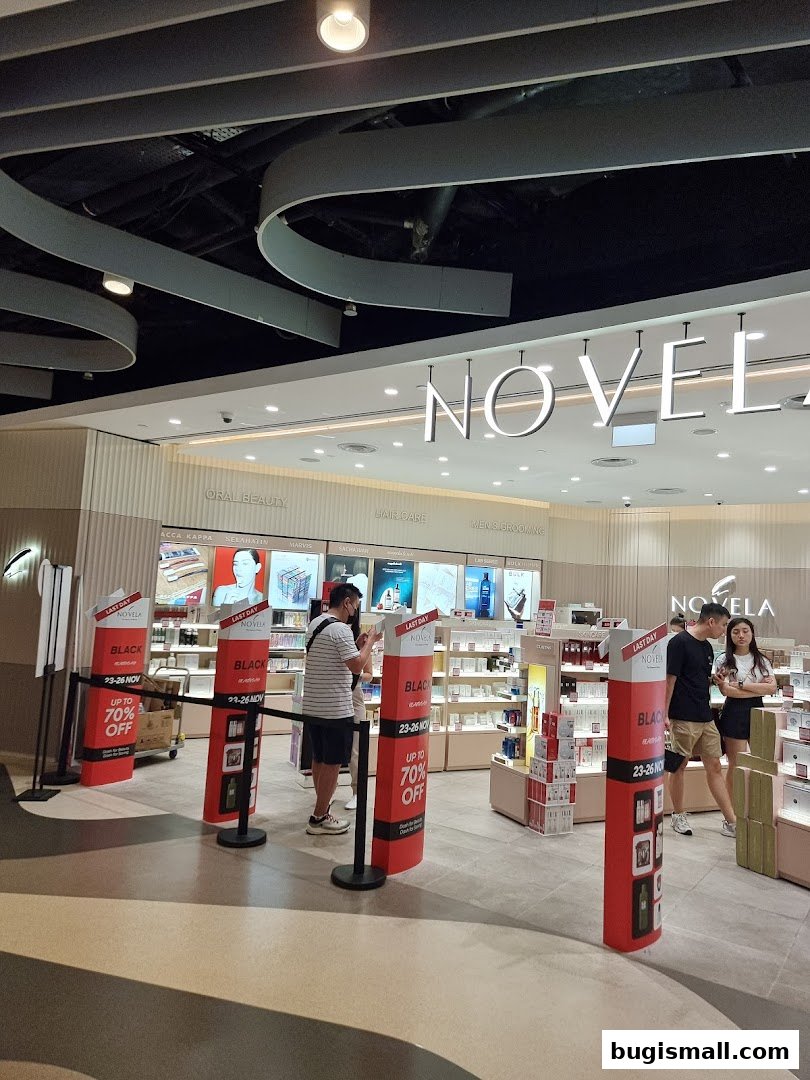 The entrance of Novela, a beauty store, with promotional displays and customers browsing.