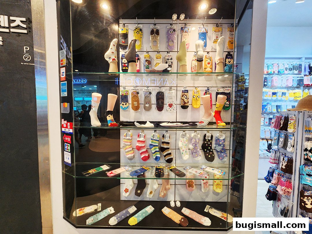 A display of colorful and patterned socks in a shop window.