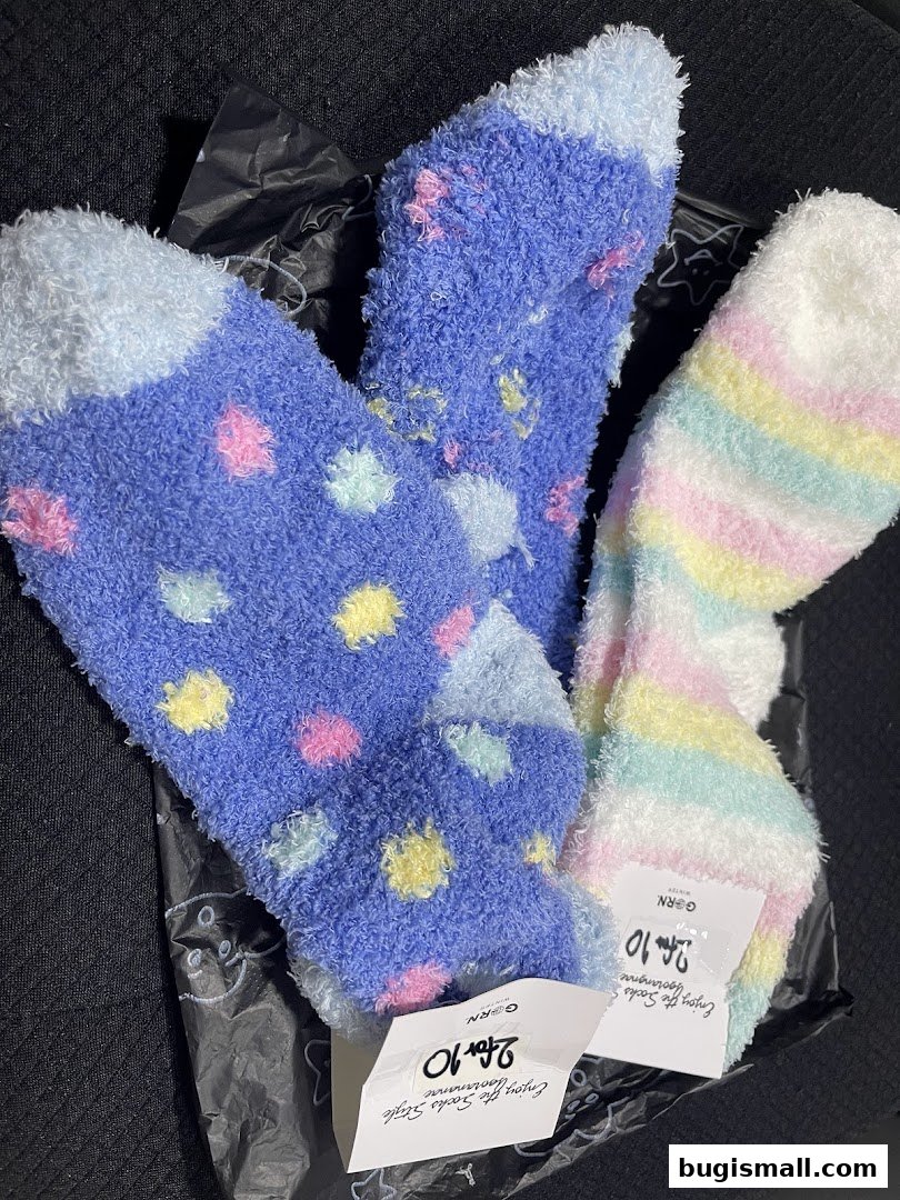 Three pairs of cozy, fuzzy socks with colorful patterns are displayed.