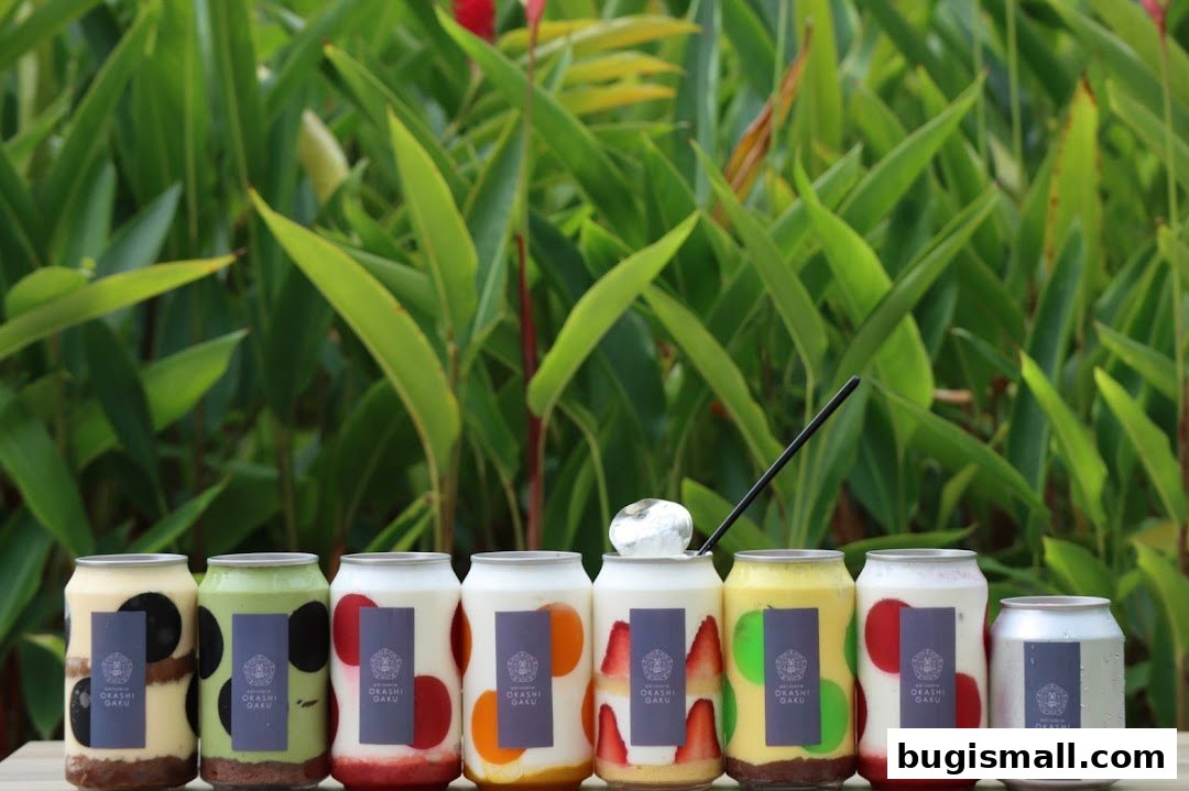 A row of colorful canned desserts with fruit and cream fillings, set against a lush green background.