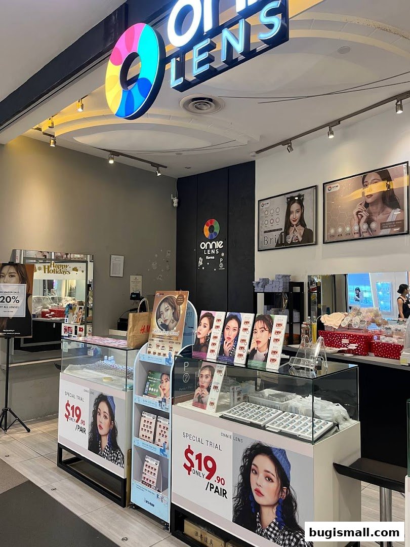 A retail shop front for ONNIE LENS, showcasing contact lenses and special trial offers.