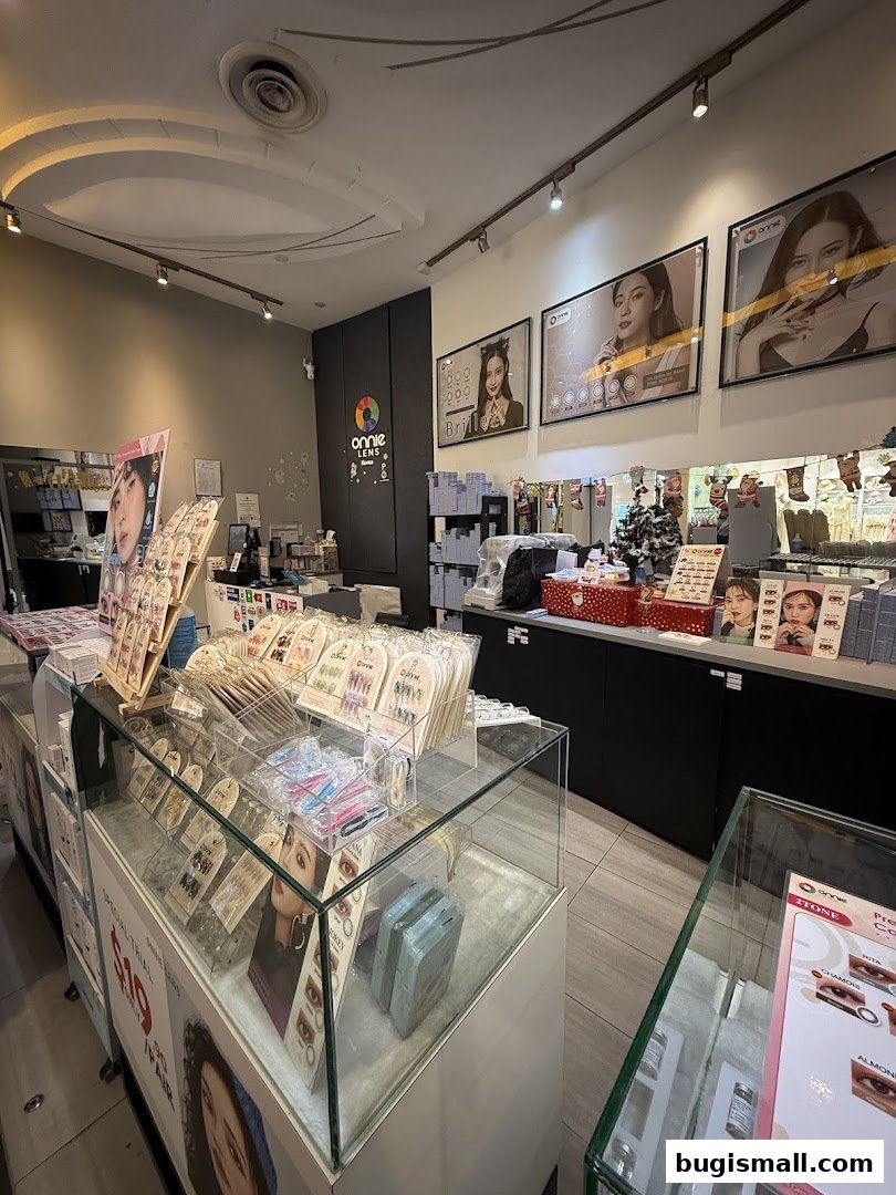Interior view of ONNIE LENS shop showcasing various contact lenses and beauty products.