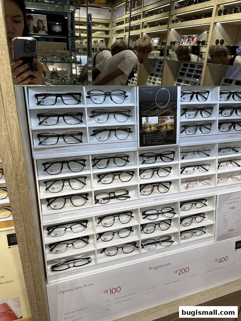 A display of various eyeglasses and lens price options at OWNDAYS Bugis.