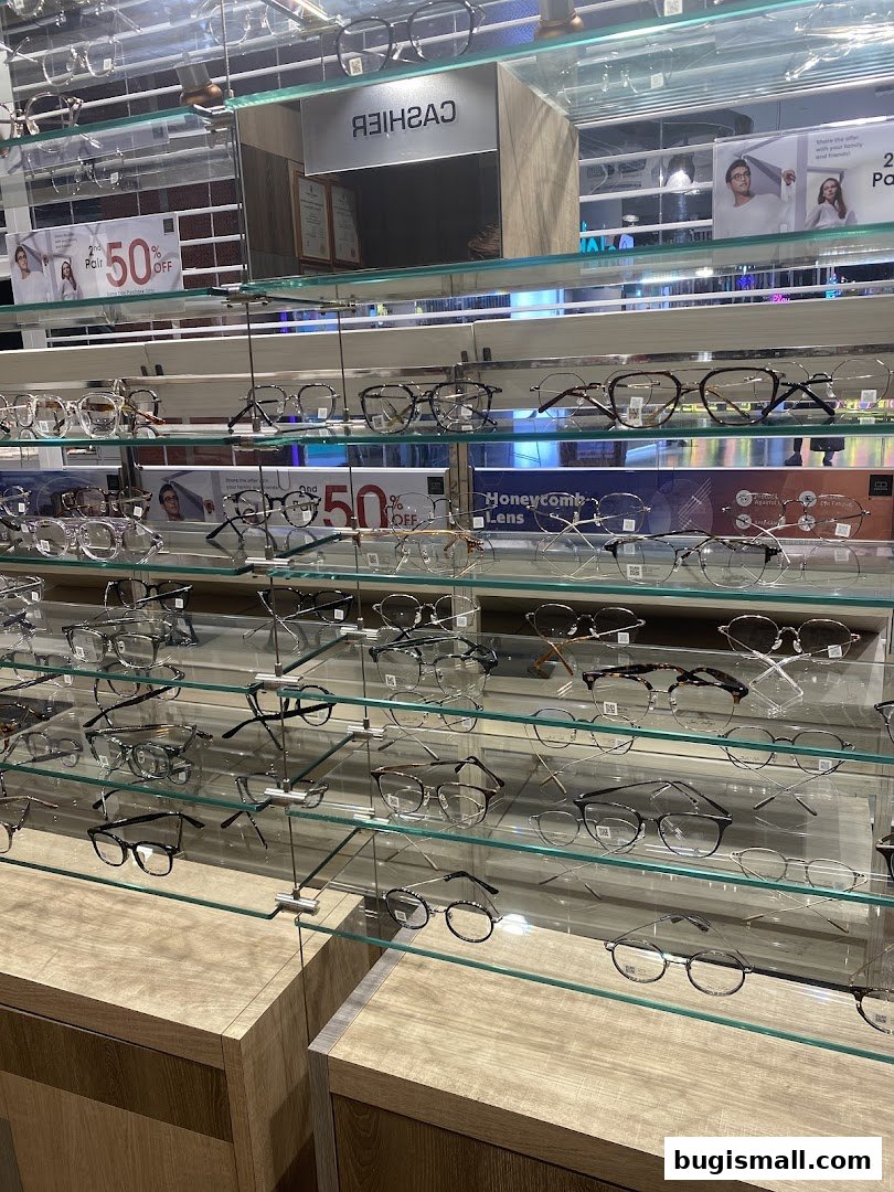 A display of various eyeglasses on shelves inside a retail store.