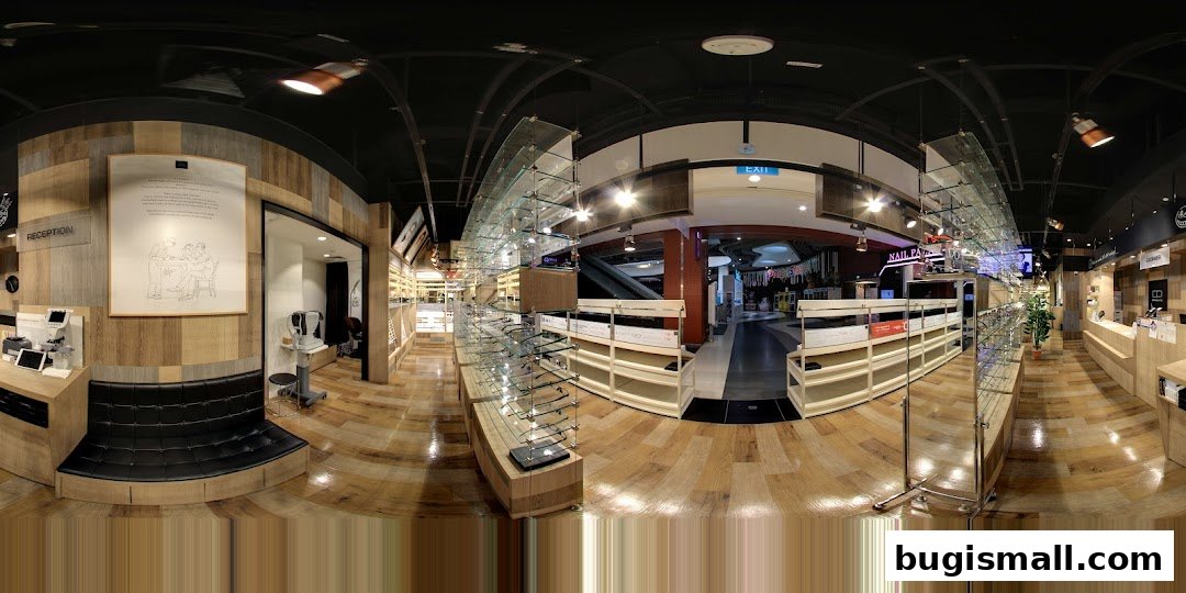 Interior view of OWNDAYS Bugis, showcasing eyewear displays and a reception area.