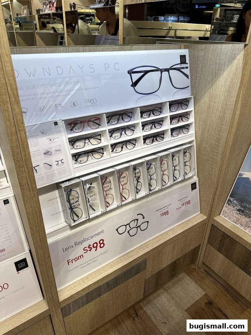 A display of various eyeglasses and lens replacement services at OWNDAYS.