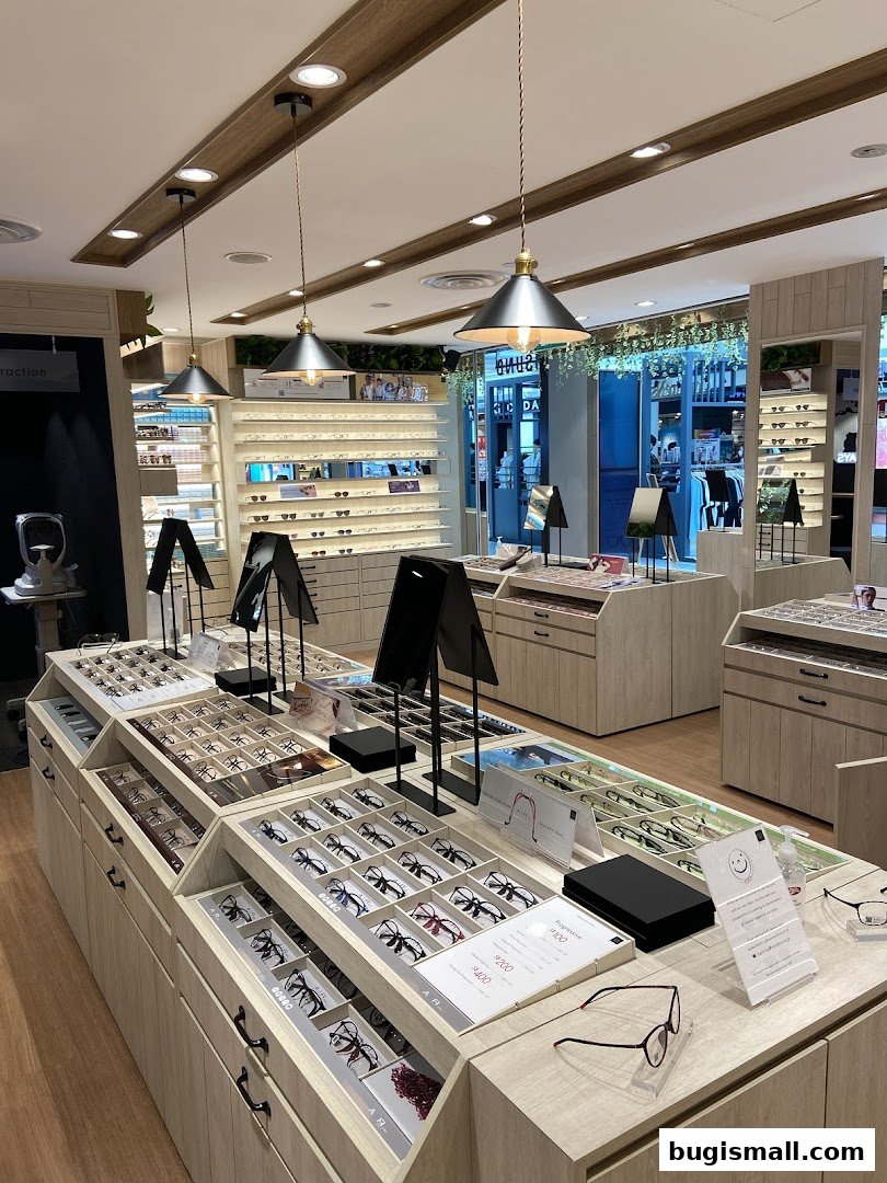 Interior view of an optical shop showcasing a wide selection of eyeglasses on display.