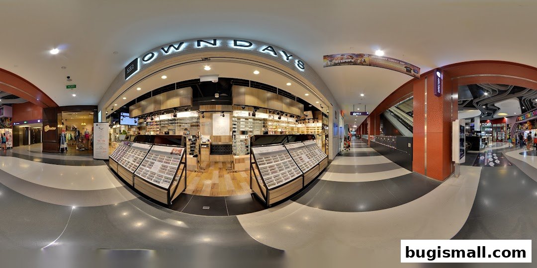 The interior of OWNDAYS Bugis, showcasing a wide selection of eyeglasses and sunglasses on display.