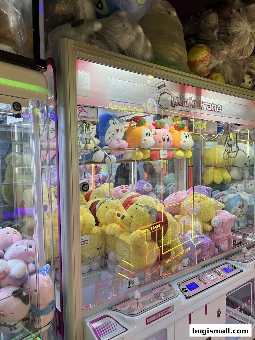 A close-up of plush toys inside a claw machine at Paco FunWorld.