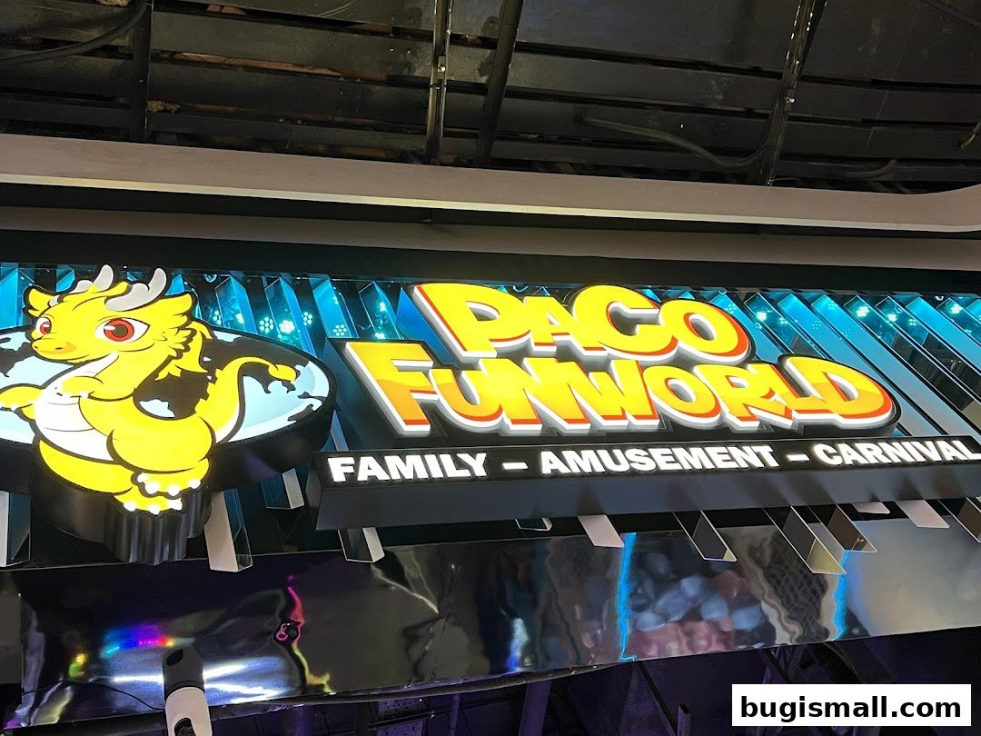 The brightly lit sign for Paco FunWorld, featuring a cartoon dragon and text indicating family amusement and carnival.