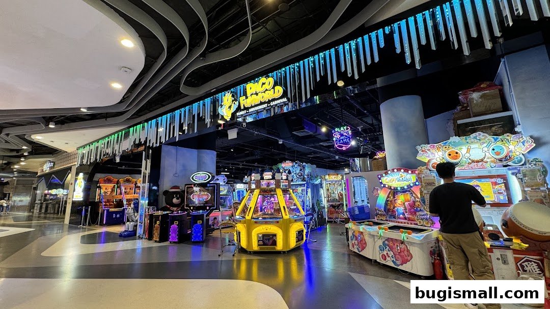 Interior view of Paco FunWorld amusement arcade with various game machines and a customer playing.