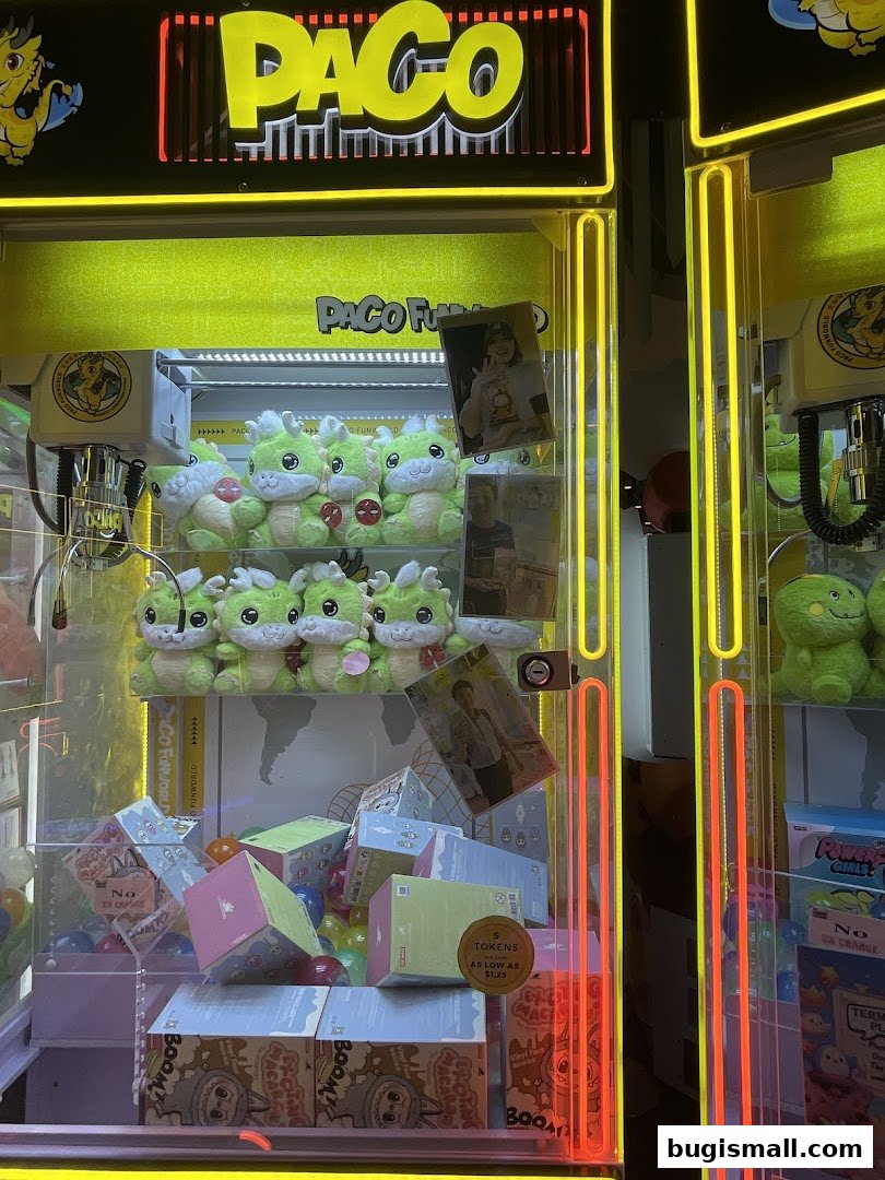A claw machine filled with plush toys and prize boxes, branded Paco FunWorld.