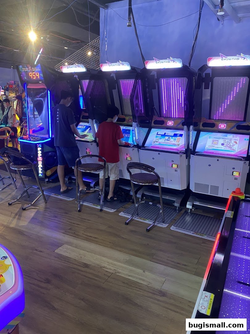 Two boys playing arcade games at Paco FunWorld.