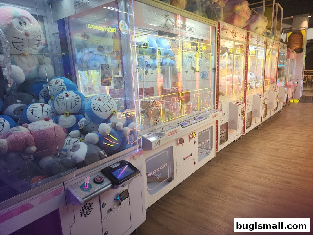 A row of claw machines filled with plush toys, including Doraemon characters.