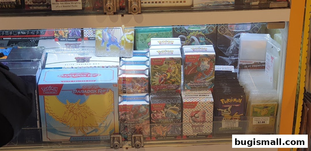 A display case filled with various Pokemon trading card game booster packs and elite trainer boxes.