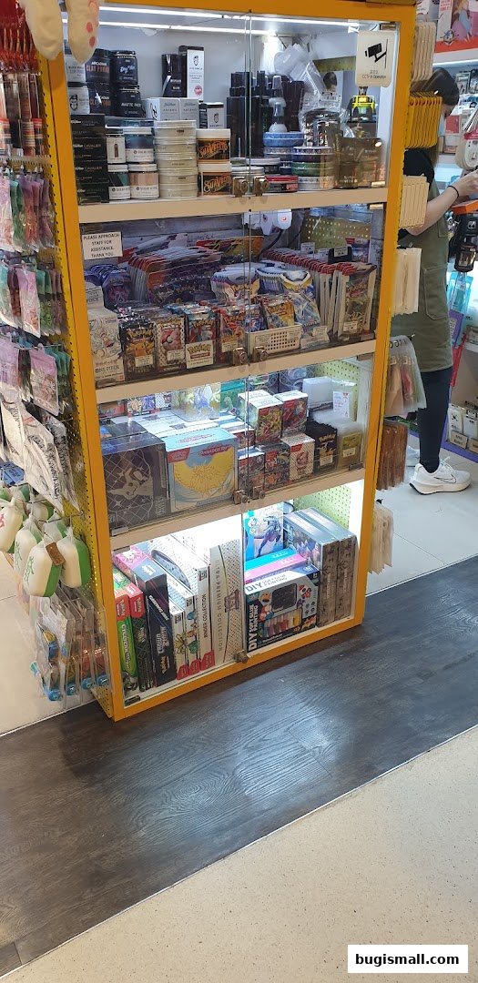 A display cabinet filled with various collectible items, including trading cards and DIY craft kits.
