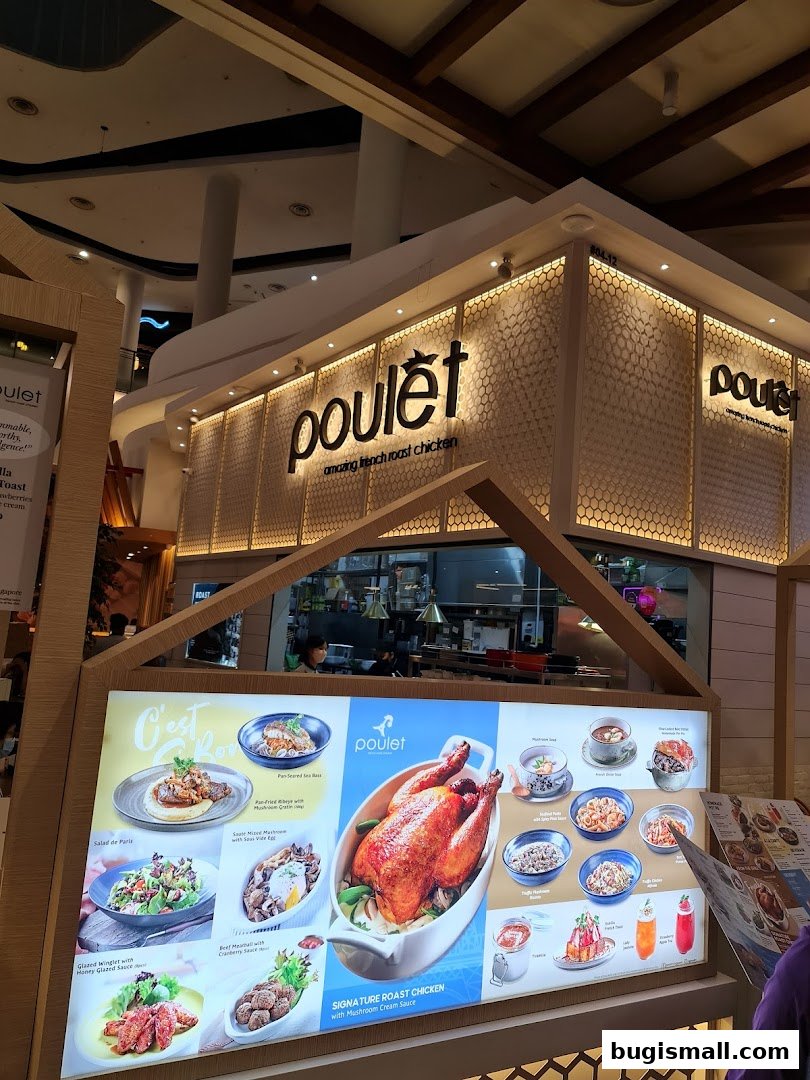 A brightly lit restaurant storefront with a large display of delicious food items.