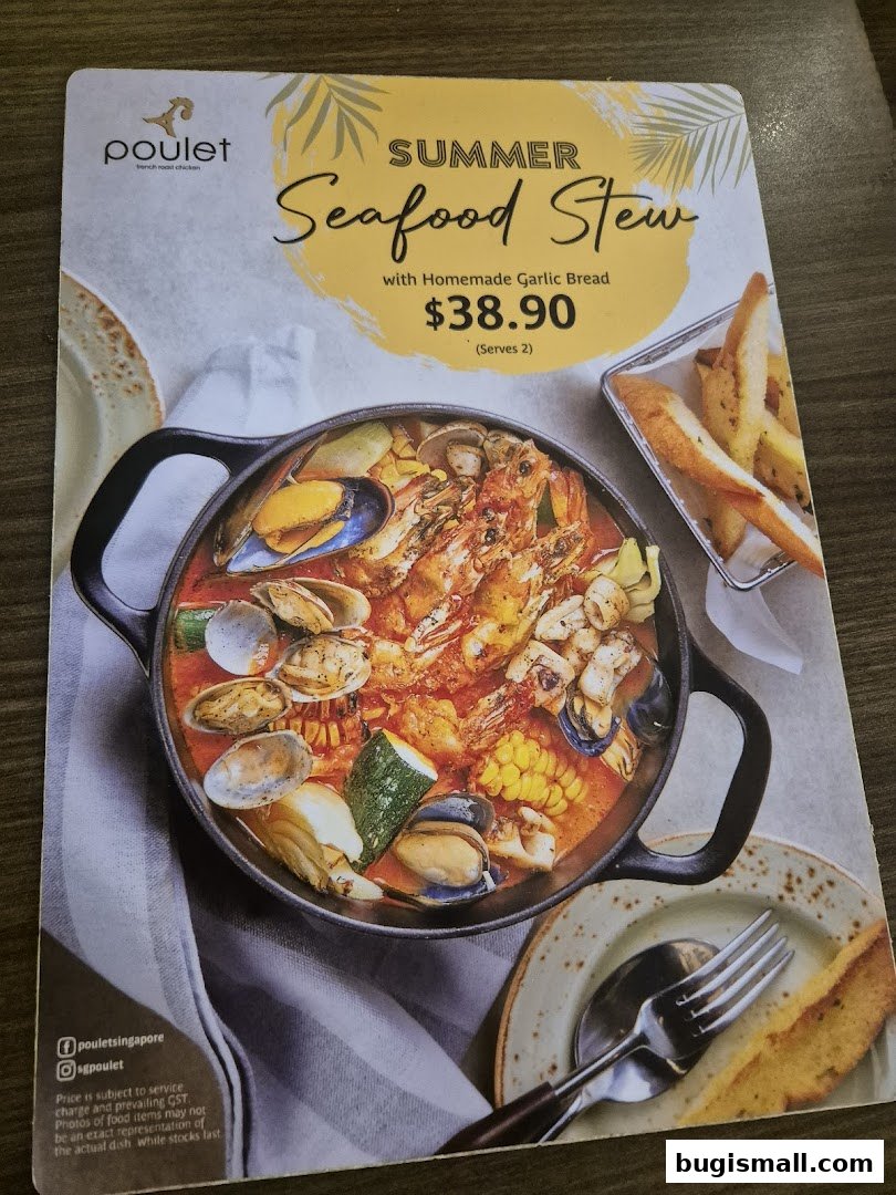 A menu item featuring a Summer Seafood Stew with Homemade Garlic Bread.