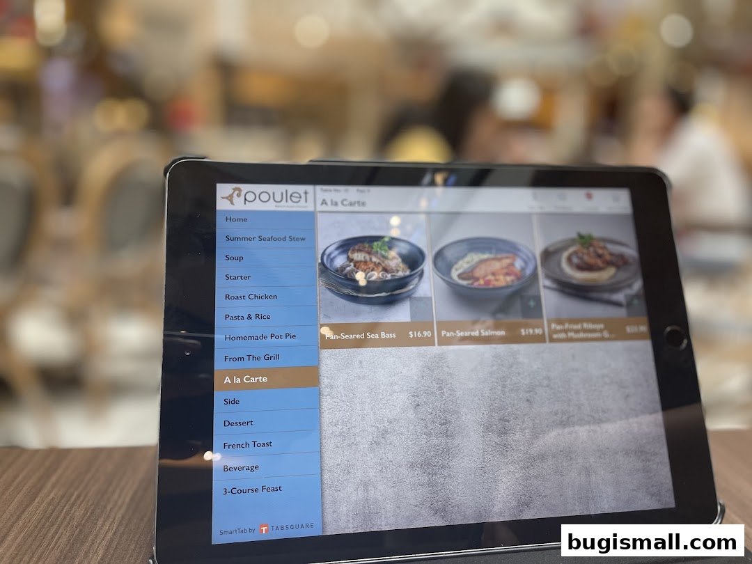 A tablet displays the menu for Poulet restaurant, showcasing various dishes and prices.