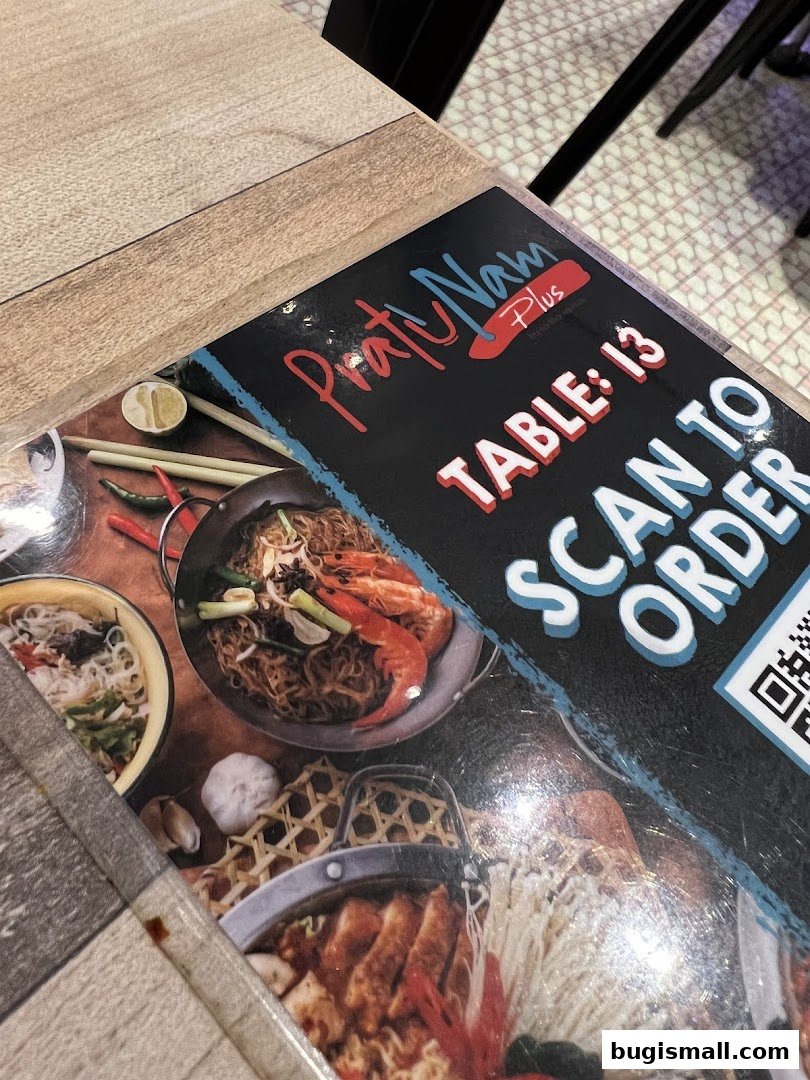 A menu from Pratunam PLUS by Soi Thai Soi Nice showing food and a QR code for ordering.