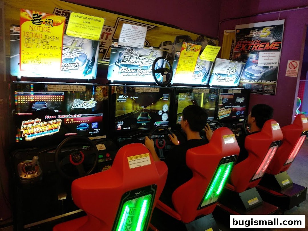 People playing racing arcade games at Prize Station.