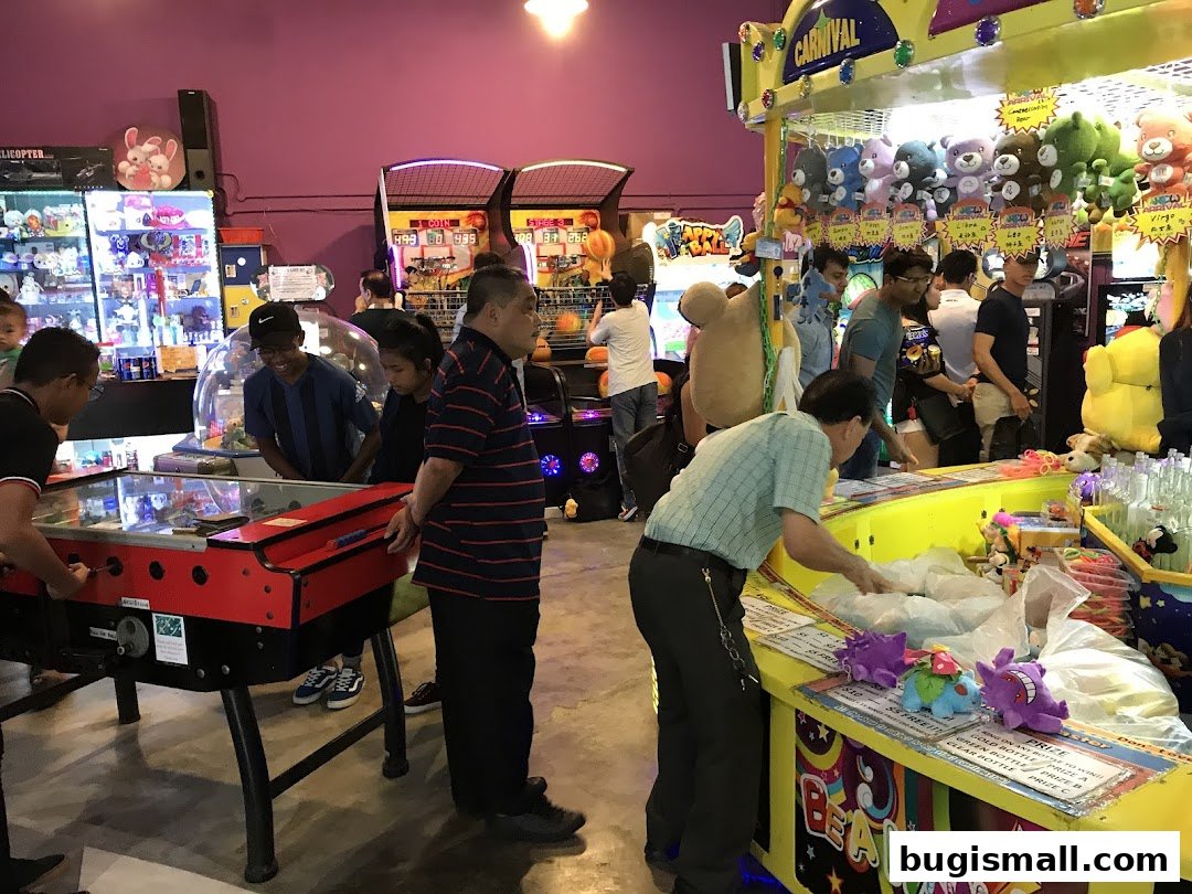 People playing arcade games and winning prizes at an entertainment center.