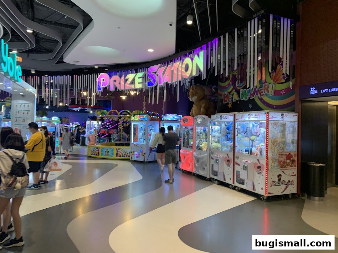 A brightly lit arcade with claw machines and game stalls, featuring the "Prize Station" sign.
