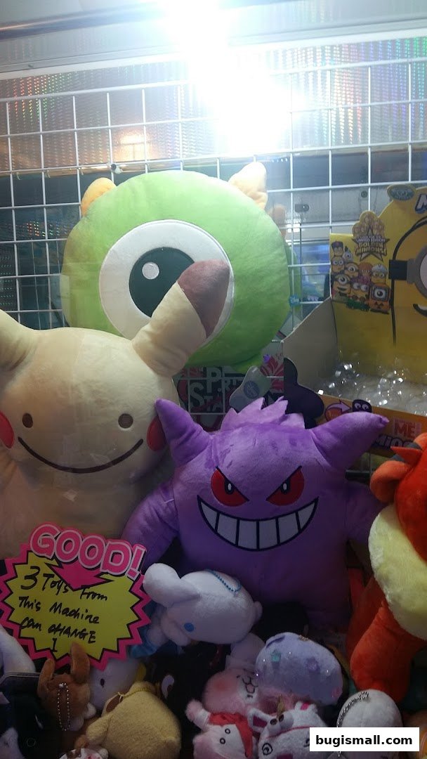 A claw machine filled with various popular anime and cartoon character plush toys.