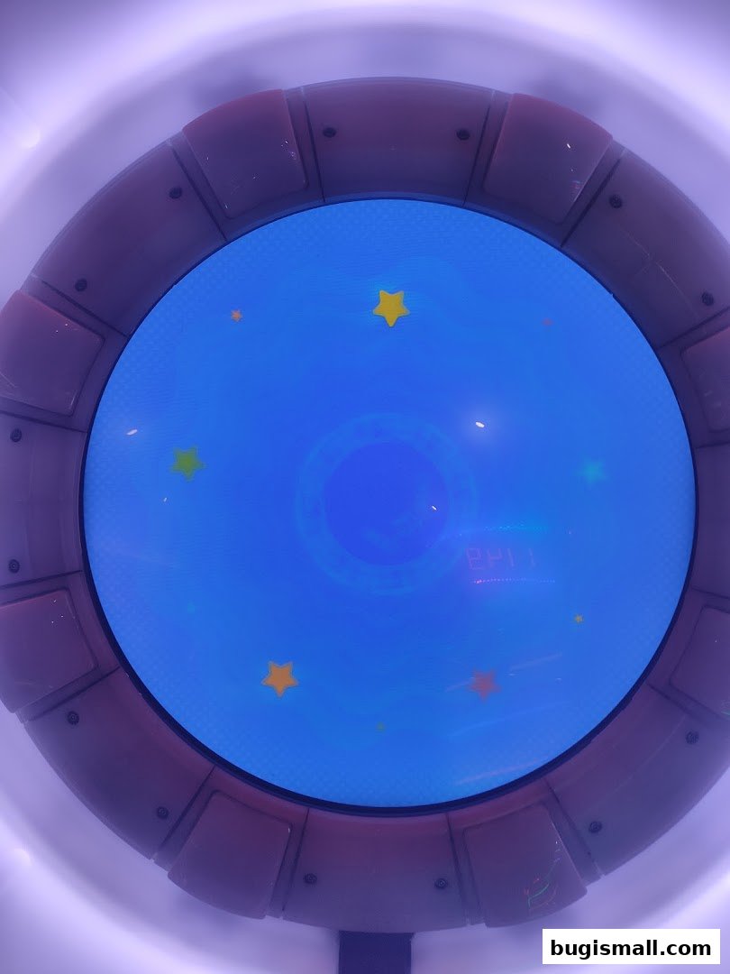 A close-up view of a circular screen with a blue background and yellow stars.