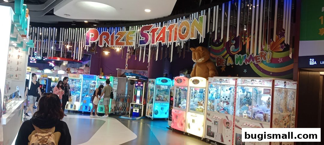 Prize Station arcade with claw machines filled with plush toys and a large Garfield mascot.