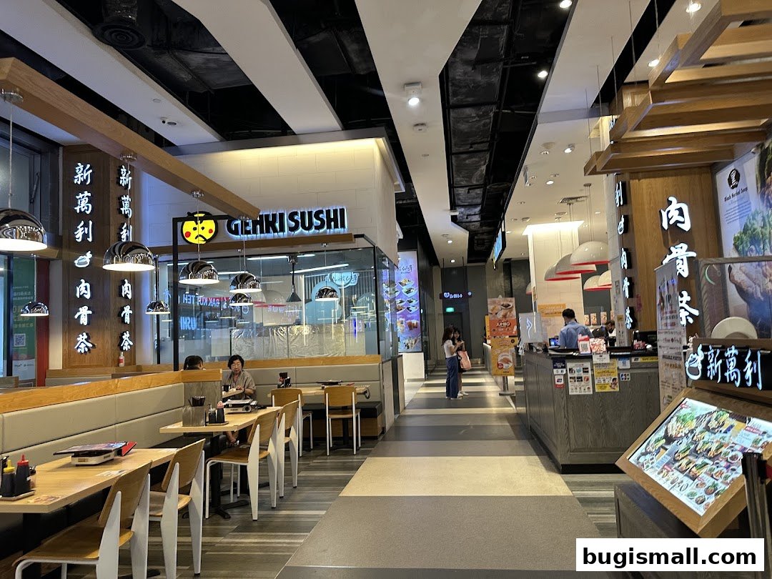 Interior view of a Genki Sushi restaurant with dining tables and a counter.