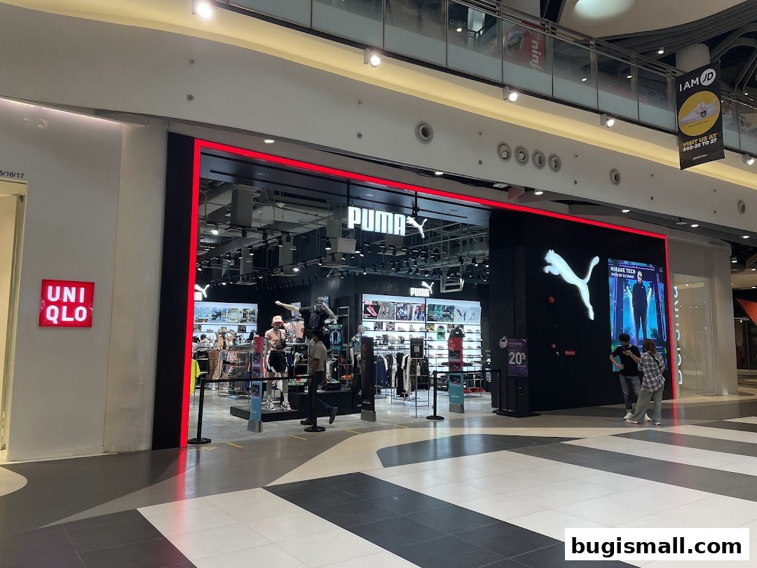 The PUMA Bugis store entrance with its iconic logo and displays of athletic wear.