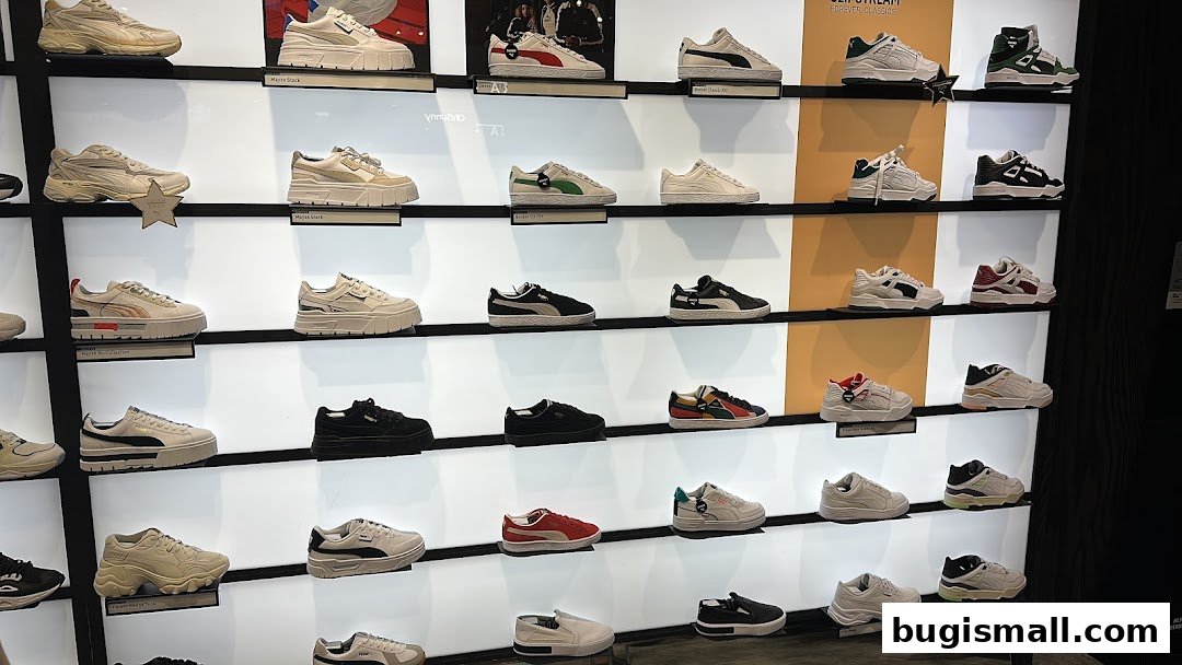 A wall display showcasing a variety of Puma sneakers in different styles and colors.