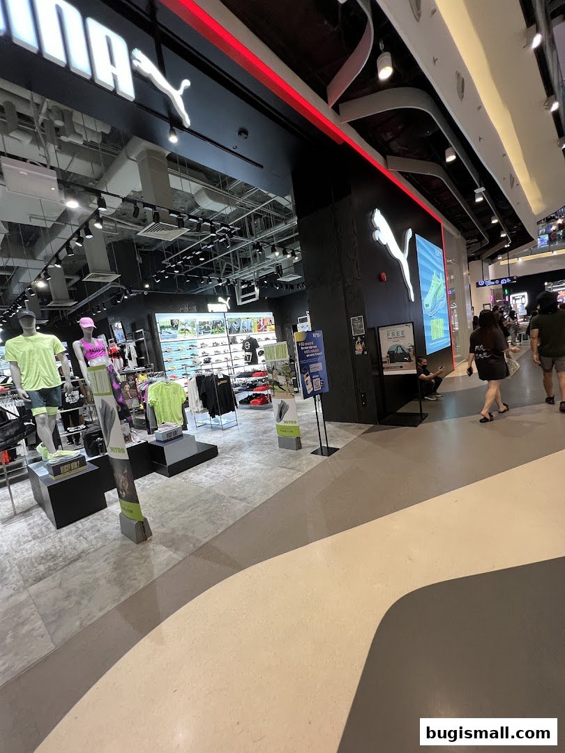 Interior view of a PUMA store showcasing athletic apparel and footwear with mannequins.