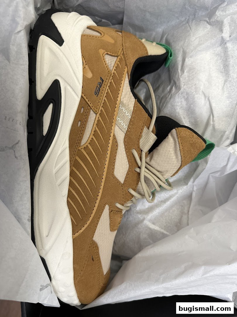 A close-up view of a stylish brown and white Puma sneaker in its box.