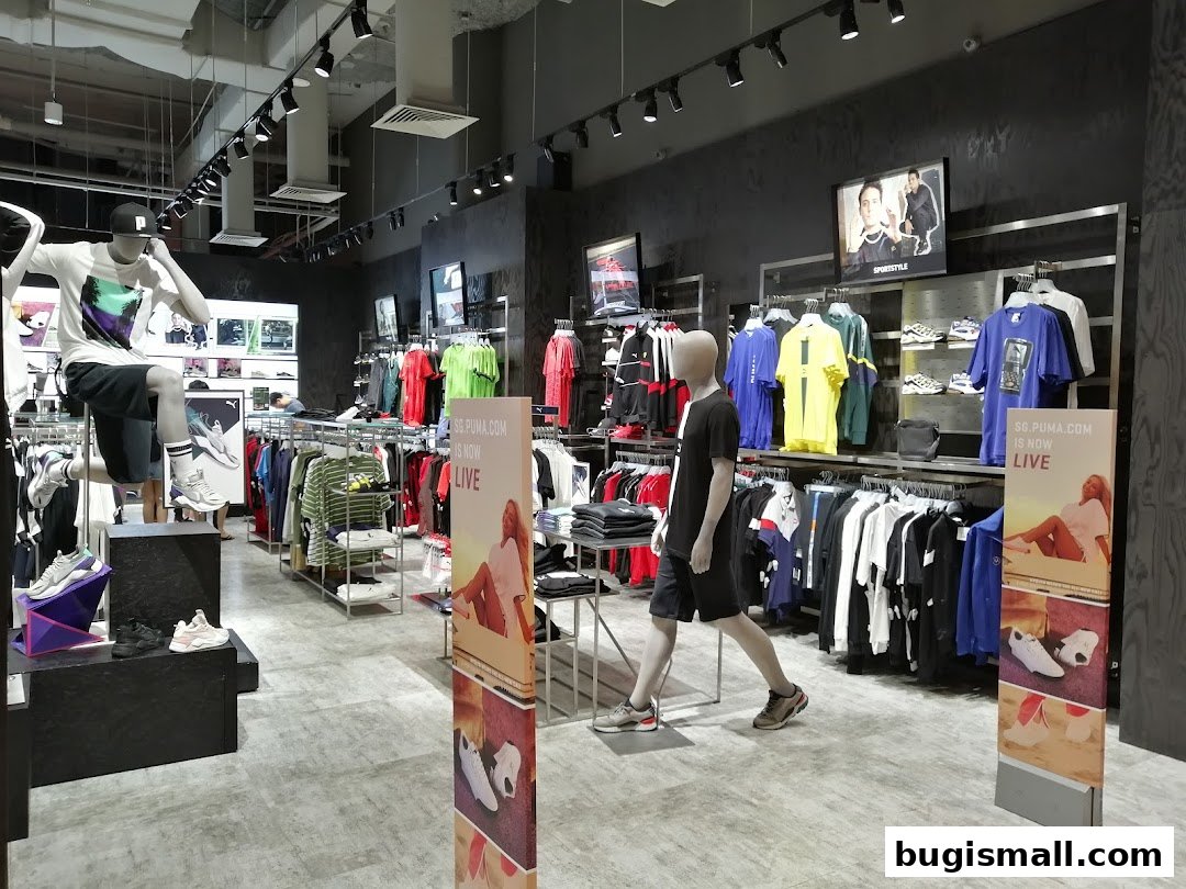 Interior view of a PUMA store showcasing apparel and footwear on display with mannequins.