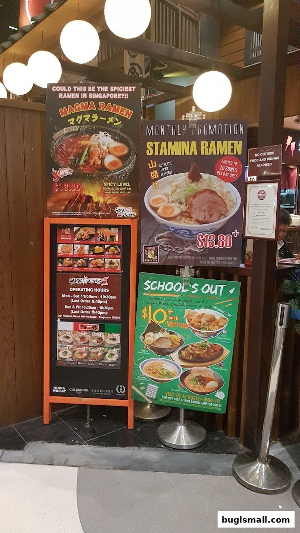 A display of promotional posters for Ramen Champion, featuring different ramen dishes and prices.