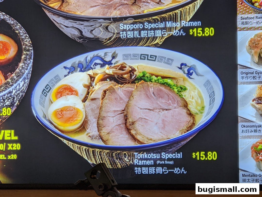 A close-up of a digital menu displaying various ramen and gyoza dishes with prices.