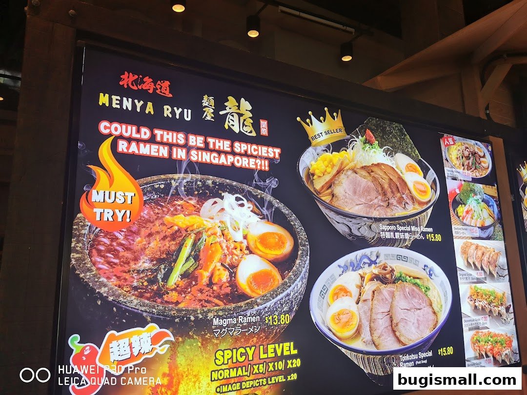 A vibrant menu display for Ramen Champion, showcasing spicy ramen and other Japanese dishes.