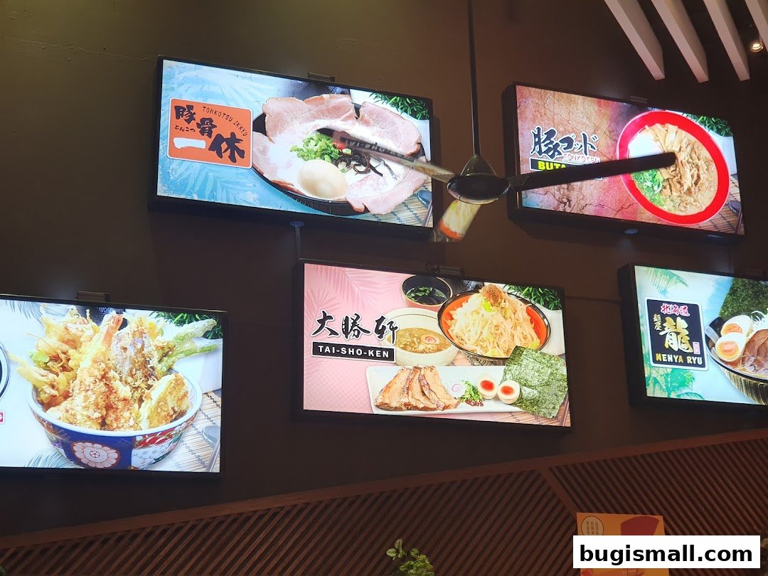 Digital screens display various ramen dishes and tempura at Ramen Champion.
