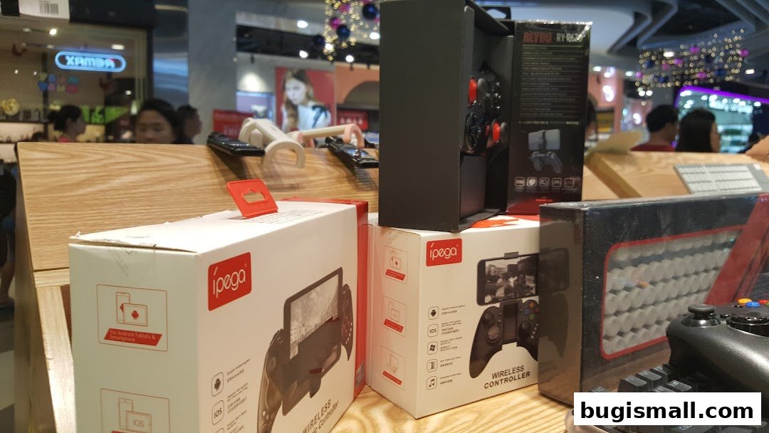 A display of ipega wireless controllers and other gaming accessories in a retail store.