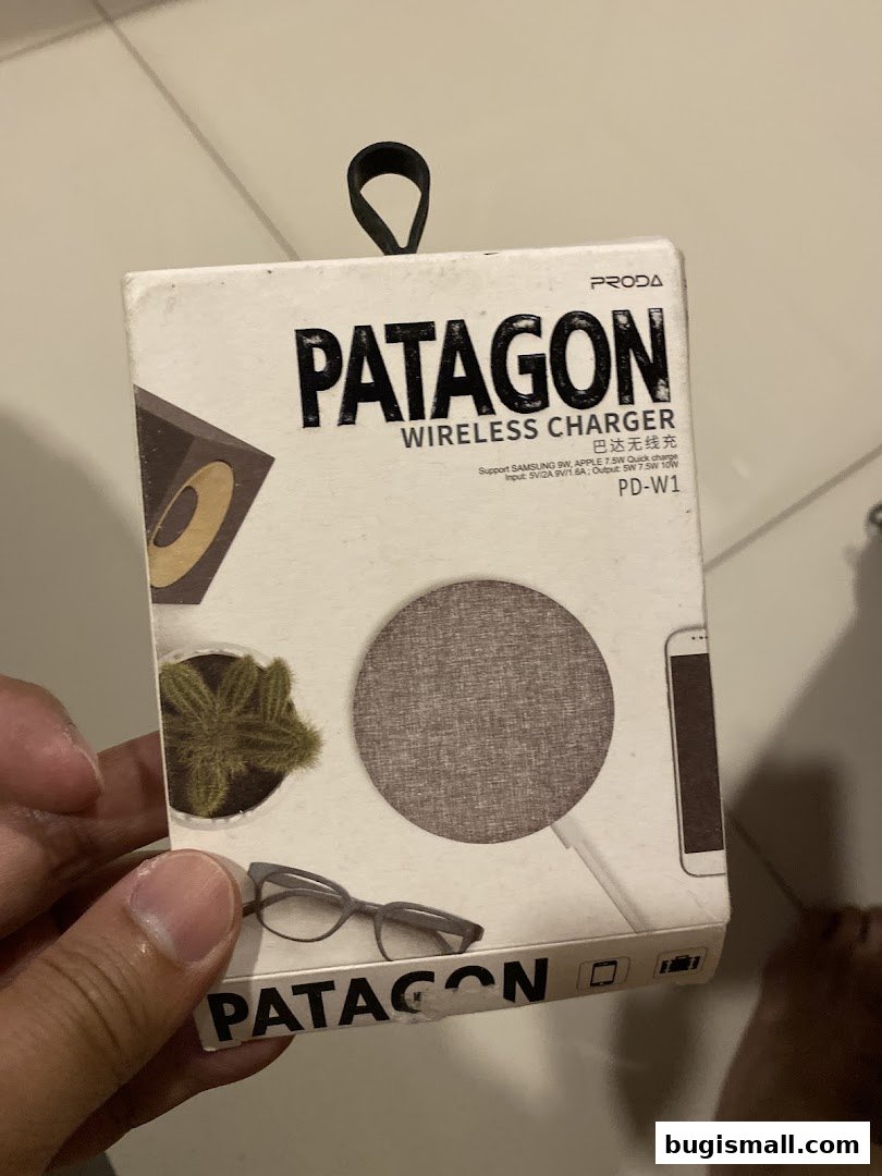 A hand holds a box for a PRODA PATAGON wireless charger with product images.