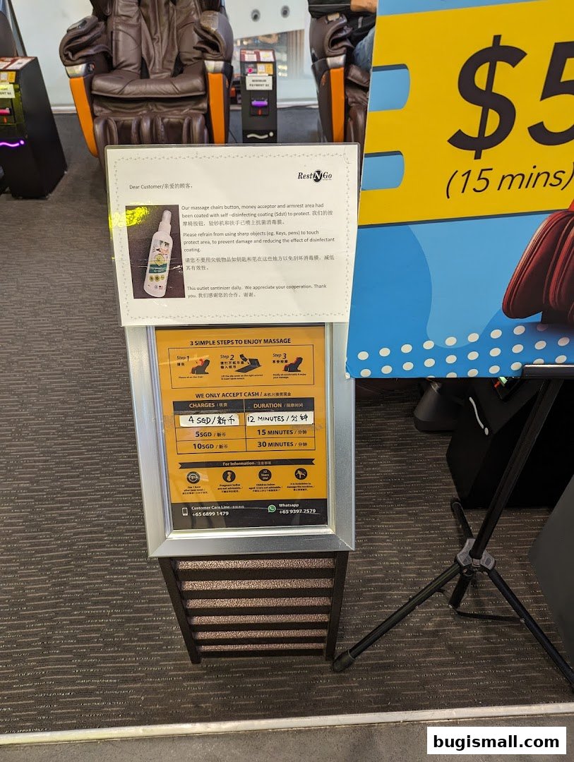 A sign detailing massage chair charges and duration, with massage chairs in the background.